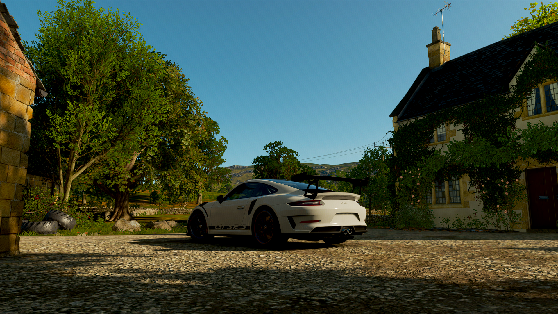 A stunning HD desktop wallpaper featuring a sleek sports car from Forza Horizon 4, set against a picturesque rural landscape with trees and a charming cottage.