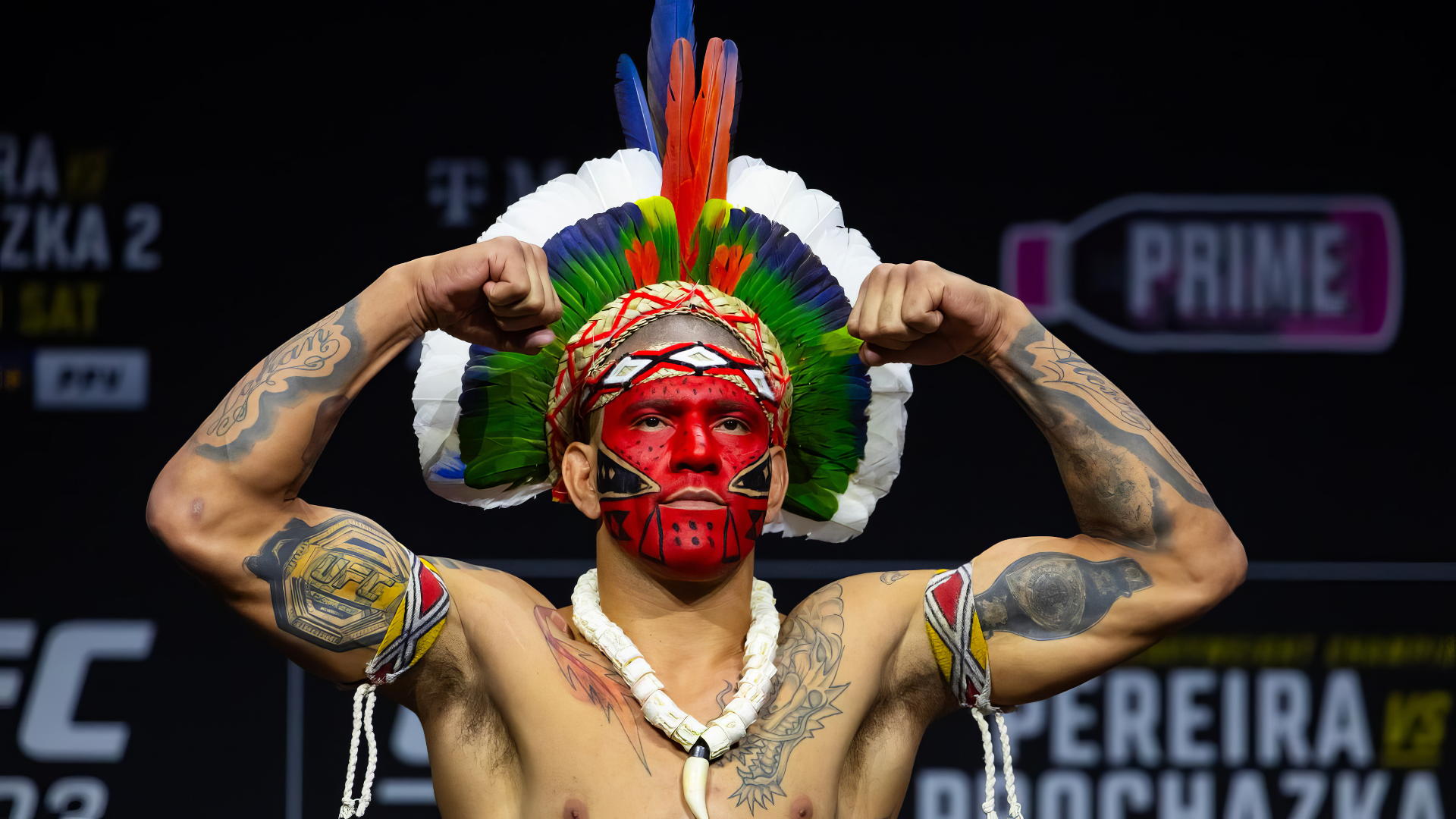 Alex Pereira showcases his powerful presence with a striking pose, wearing traditional attire, ready for the UFC. This HD wallpaper captures the intensity of MMA sports.