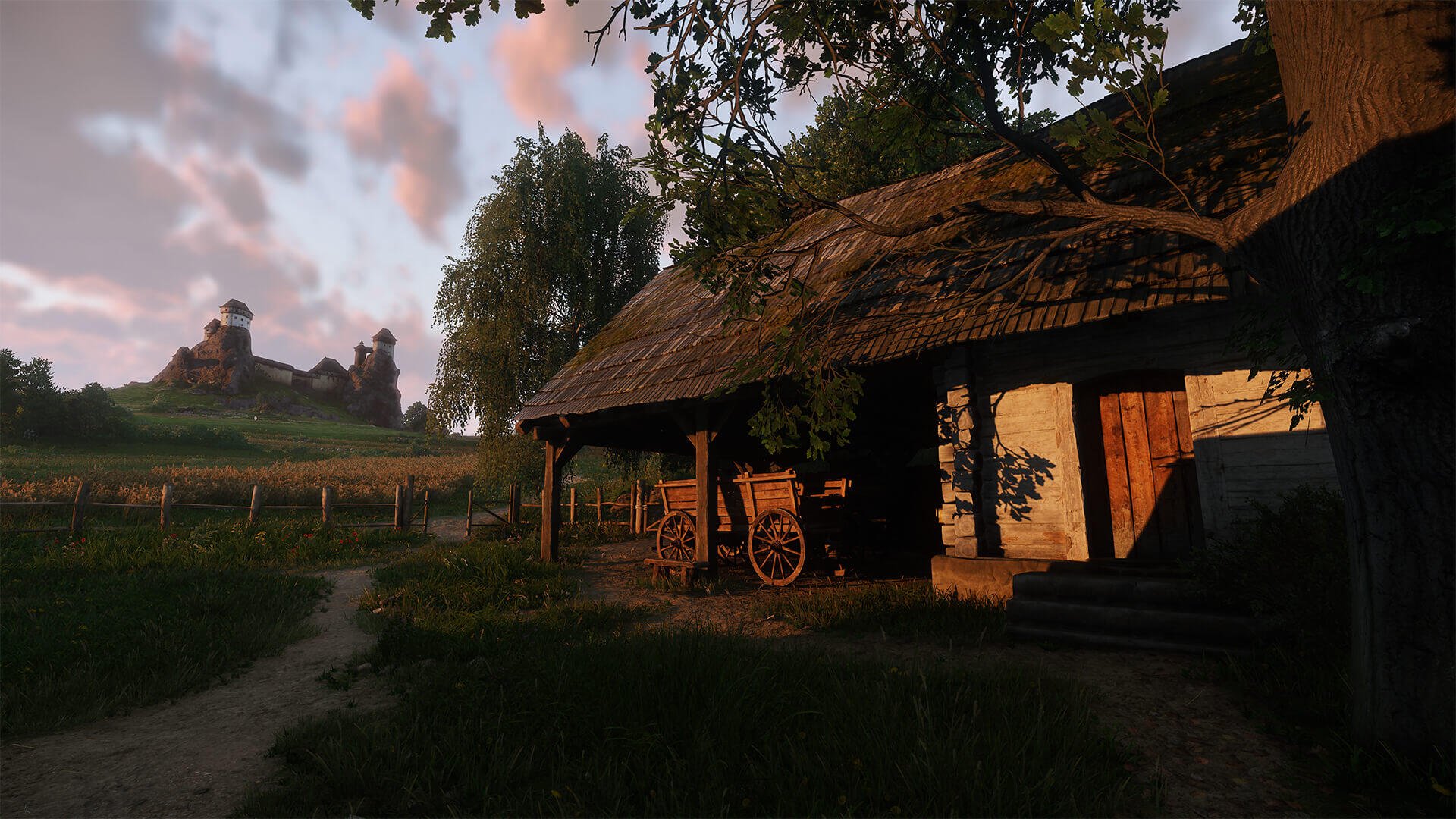 A serene medieval scene from Kingdom Come: Deliverance II, featuring a rustic wooden house, a cart, and lush greenery under a vibrant sky, serving as an HD PC desktop wallpaper.