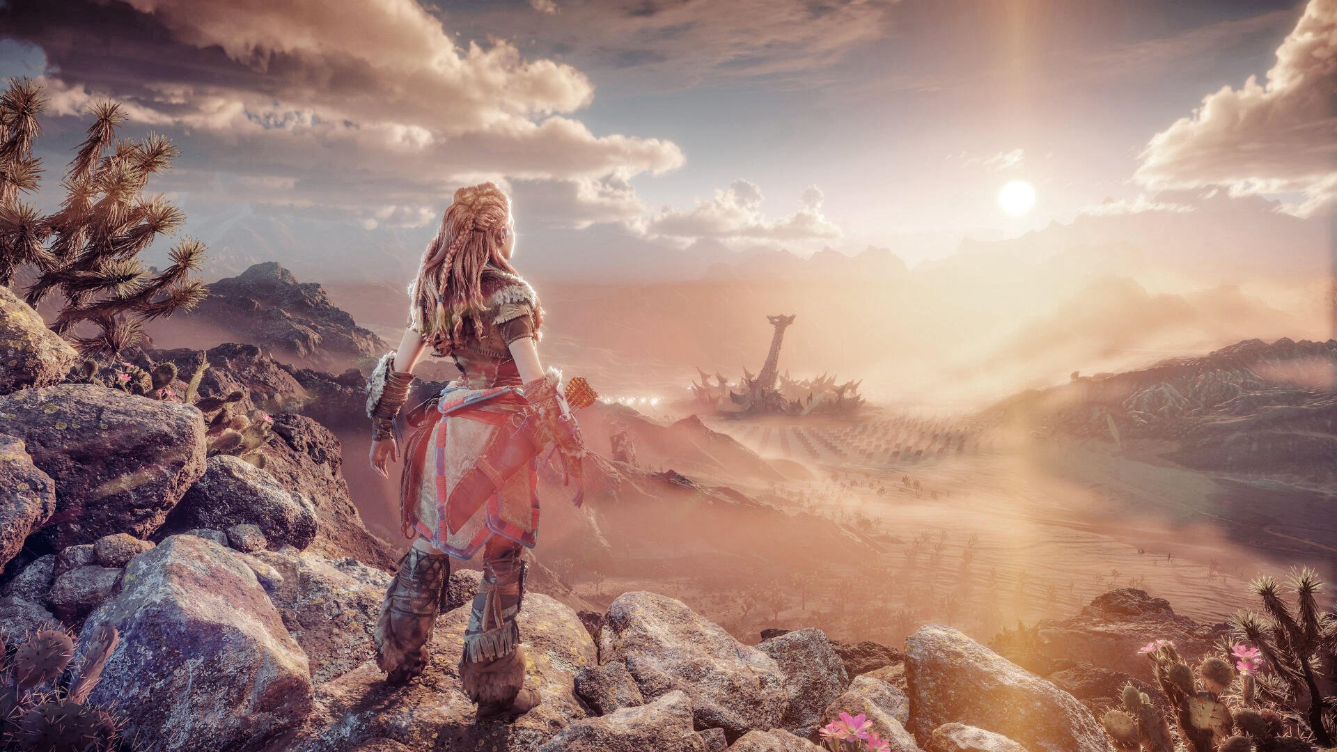Horizon Forbidden West 4K Ultra HD PC desktop wallpaper: Aloy stands on a rocky ridge at sunrise, overlooking a vast sunlit post‑apocalyptic landscape with distant machines and ruined structures.
