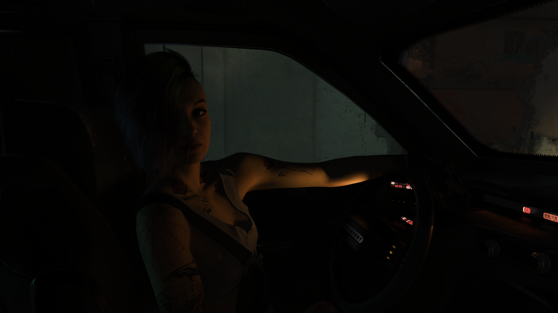 A high-definition desktop wallpaper featuring Judy from Cyberpunk 2077, sitting in a car, illuminated by soft lighting against a dark background.