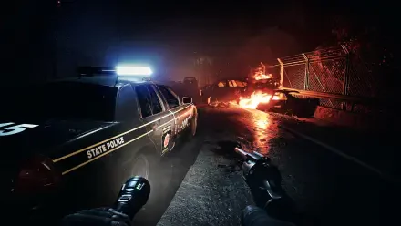 Dark and atmospheric HD wallpaper from No More Room In Hell 2, featuring a state police car with flashing lights and a burning vehicle in a gritty, zombie-infested landscape.