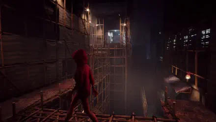 A moody HD wallpaper from the video game Slitterhead, depicting a character in a red hoodie standing on scaffolding, overlooking a dark, atmospheric construction site.