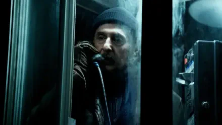 A dramatic scene from the TV show *Severance*, featuring a character in a phone booth, shrouded in mist, conveying a sense of tension and intrigue in this 4K Ultra HD wallpaper.