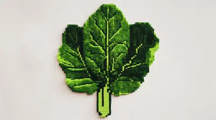 A vibrant, pixel art representation of spinach leaves, showcasing rich green hues, perfect as a 4K Ultra HD desktop wallpaper and background.