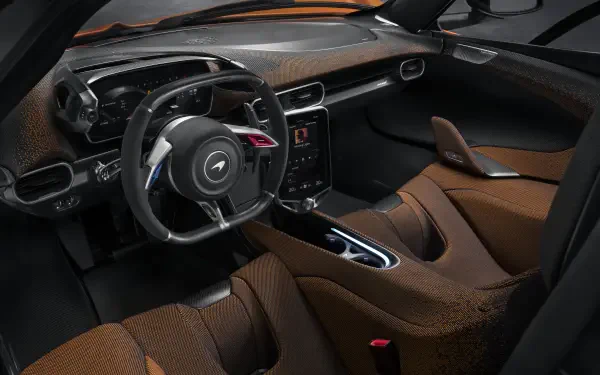 Interior view of a McLaren W1, showcasing its sleek design and luxurious brown leather seats. Captured in stunning 8K Ultra HD for a striking desktop wallpaper.
