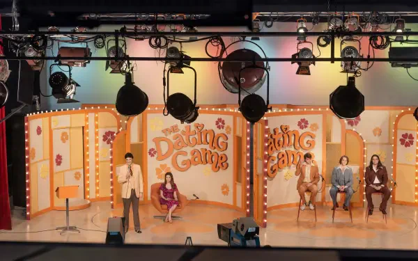 A vibrant scene from Woman of the Hour, showcasing the set of a dating game show with colorful backgrounds and stage lighting, captured in stunning 8K Ultra HD resolution.