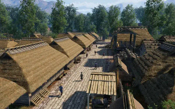 A serene view of a village in Sengoku Dynasty, showcasing traditional thatched-roof buildings along a stone path, surrounded by lush greenery and mountains in the background.
