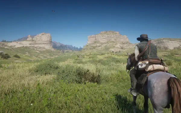 A serene landscape from *Red Dead Redemption 2*, showcasing a character on horseback, surrounded by lush greenery and rocky formations under a clear blue sky. Ideal HD wallpaper for gamers.