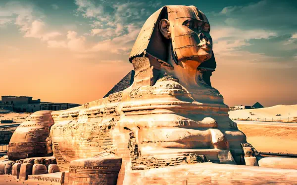 A stunning 4K Ultra HD desktop wallpaper featuring the iconic Sphinx, showcasing its majestic form against a vibrant sunset sky and the serene desert landscape.