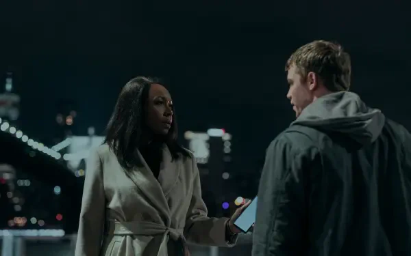 A scene from the TV show The Night Agent featuring Amanda Warren, showing a tense conversation at night with city lights in the background. HD desktop wallpaper and background.