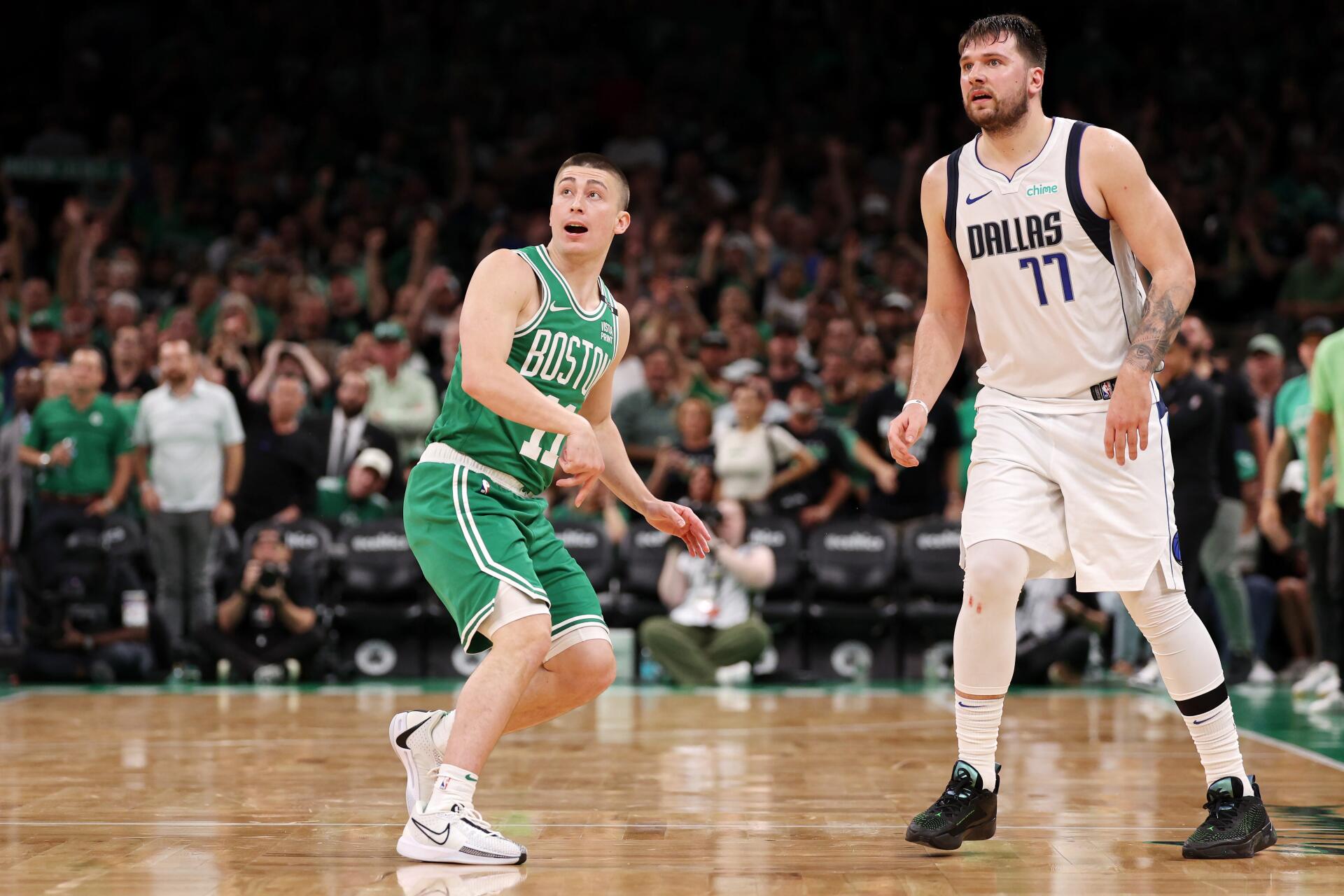Payton Pritchard of the Boston Celtics reacts during a game against Luka Dončić of the Dallas Mavericks, captured in this vibrant 4K Ultra HD desktop wallpaper.