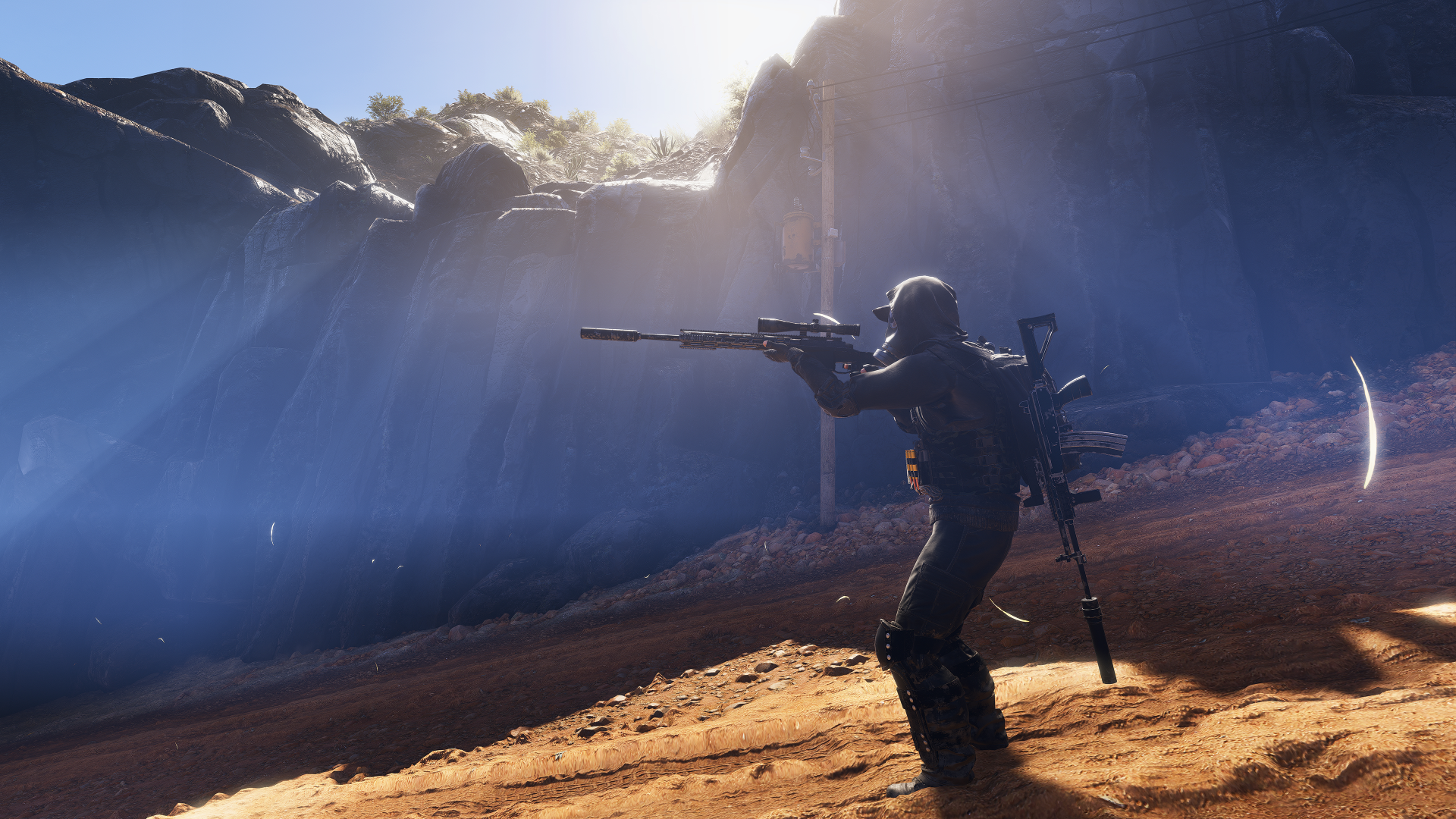 A sniper in Tom Clancy’s Ghost Recon Wildlands takes aim amidst a dramatic landscape, highlighted by sunlight filtering through the mountains, set as a stunning 4K Ultra HD wallpaper.