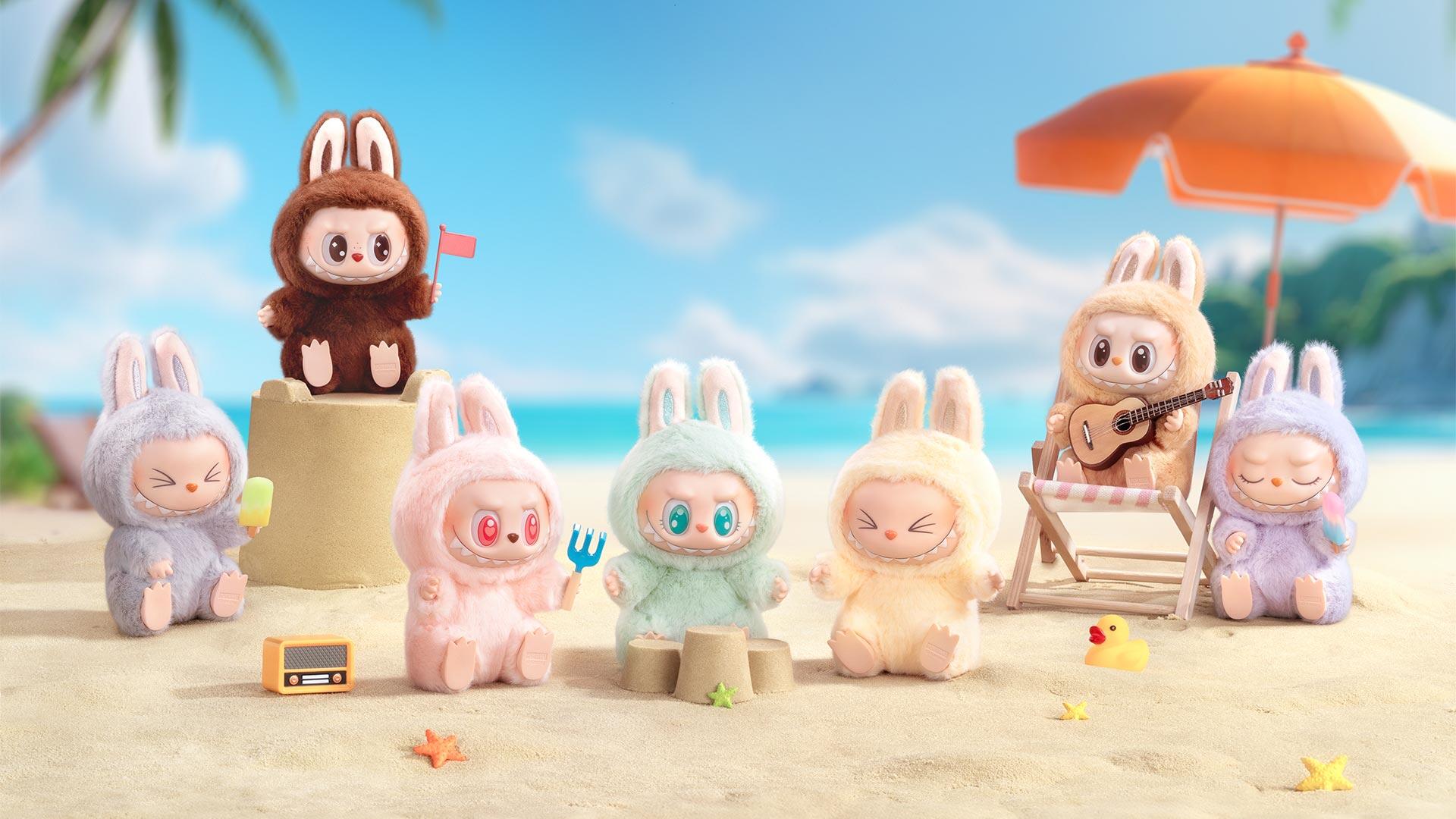 Labubu characters in bunny costumes enjoy a sunny beach scene with sandcastles, musical guitar, and bright umbrellas in this HD PC desktop wallpaper background.