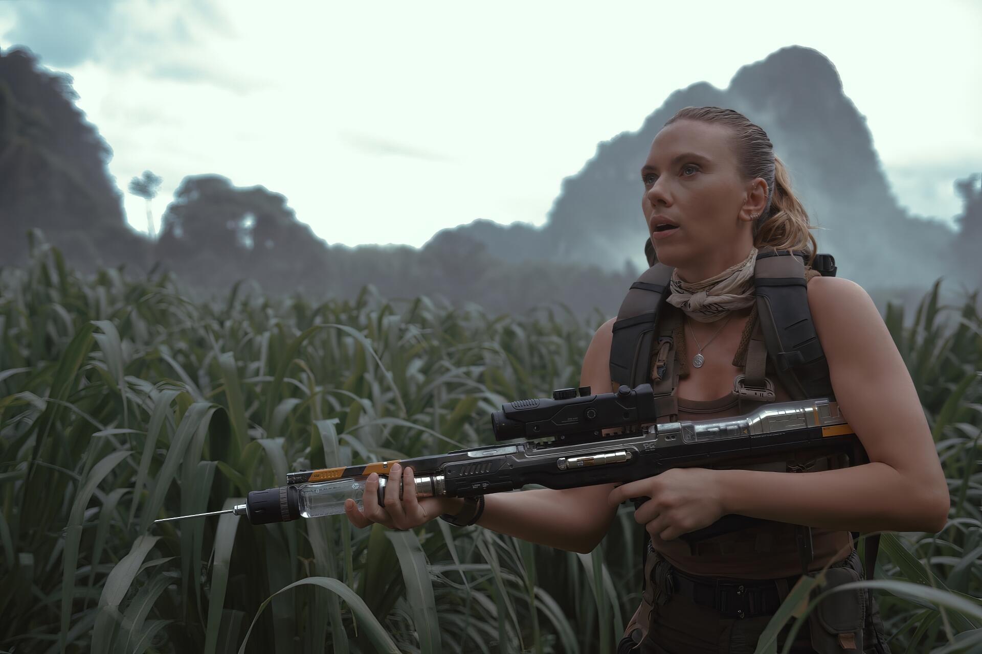 HD PC desktop wallpaper featuring Scarlett Johansson in a tense scene from the movie Jurassic World Rebirth, set against a lush, mountainous jungle backdrop.