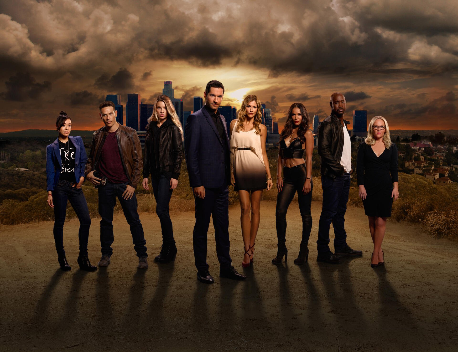 Lucifer TV Show cast standing together under a dramatic sky in a 4K Ultra HD PC desktop wallpaper and background.