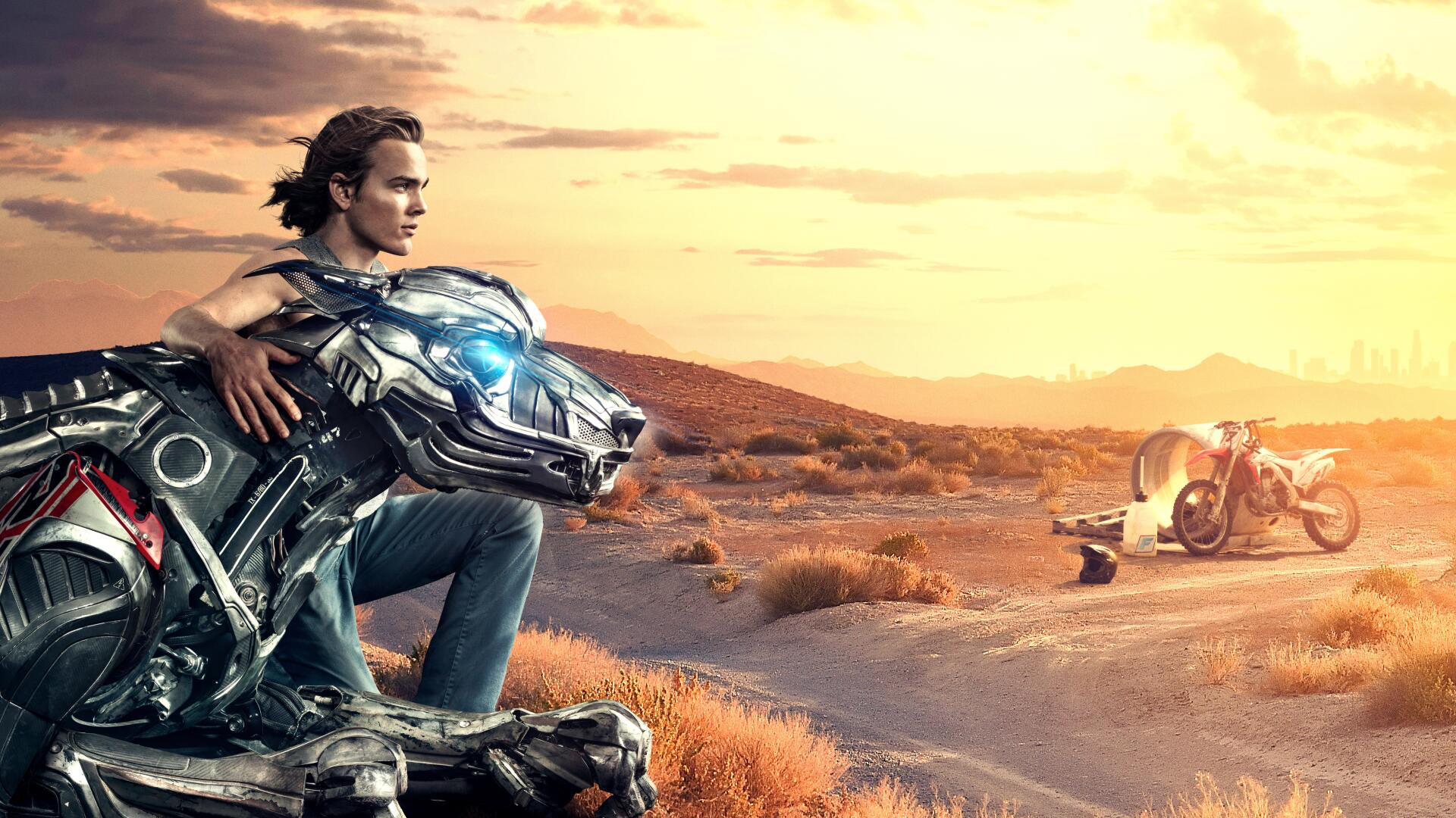 Axl (Movie) 8K Ultra HD PC desktop wallpaper — young man rests with a chrome robotic hound on a sunlit desert road, motorcycle and helmet nearby under a golden sunset.
