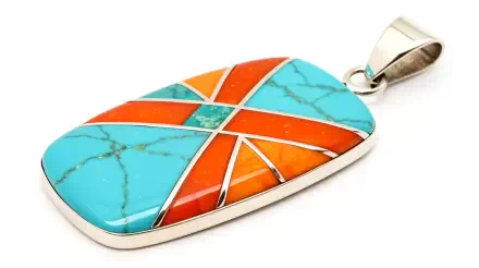 A vibrant pendant featuring turquoise and orange stones, intricately designed with geometric patterns, showcased in a 4K Ultra HD PC desktop wallpaper and background.