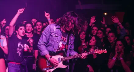 A vibrant 4K Ultra HD wallpaper captures a passionate guitar performance in a lively crowd, embodying the energy and excitement of Rock & Roll music.