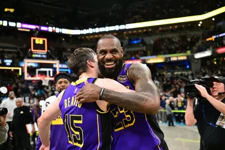 LeBron James and Austin Reaves celebrate a thrilling moment on the court, showcasing their chemistry as members of the Los Angeles Lakers in this vibrant HD wallpaper.