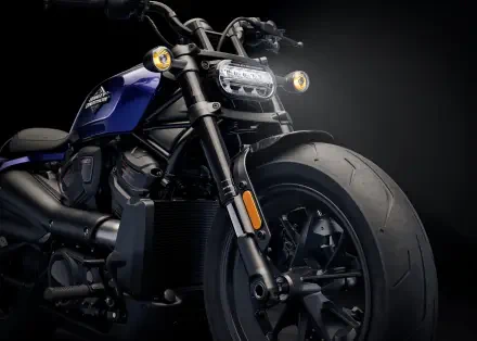 A striking close-up of a Harley-Davidson Sportster motorcycle, showcasing its powerful front wheel and sleek design against a dark background, ideal for a 4K Ultra HD desktop wallpaper.