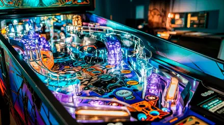 A vibrant pinball machine with illuminated features and intricate designs, showcased in a detailed 4K Ultra HD PC desktop wallpaper and background.
