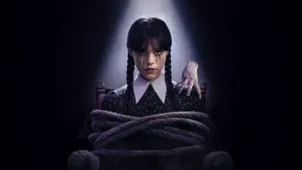 5K Ultra HD PC desktop wallpaper: Wednesday in braids and black dress, bound by thick ropes with a pale hand on her shoulder, spotlighted against a dark background.