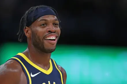HD PC desktop wallpaper featuring a close-up of basketball player Buddy Hield smiling during a game.