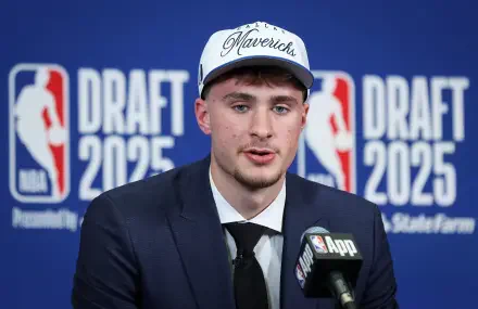 Cooper Flagg in a suit and Mavericks cap at the 2025 NBA Draft, featured in a high-definition PC desktop wallpaper and background.