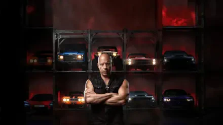 Bald, muscular man with arms crossed stands before stacked sports cars in moody red lighting — Fast X 4K Ultra HD PC desktop wallpaper and background.