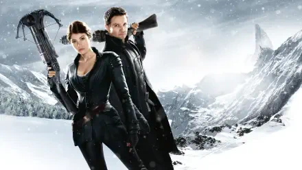 Hansel & Gretel: Witch Hunters 4K Ultra HD PC desktop wallpaper - two leather-clad hunters with crossbow and rifle stand amid a snowy, windswept mountain landscape.