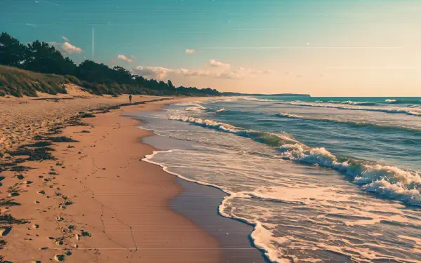 A serene seashore scene at sunset, showcasing gentle waves lapping against a sandy beach, ideal for a 4K Ultra HD PC desktop wallpaper and background.