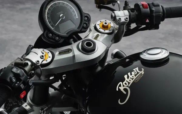 Close-up of the Triumph Bonneville Bobber TFC motorcycle, showcasing its sleek handlebars, intricate controls, and stylish design. A striking 4K Ultra HD desktop wallpaper.