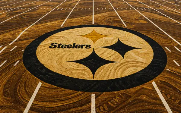 A high-resolution 4K Ultra HD wallpaper featuring the Pittsburgh Steelers logo centered on a field, showcasing the team's iconic colors and design.