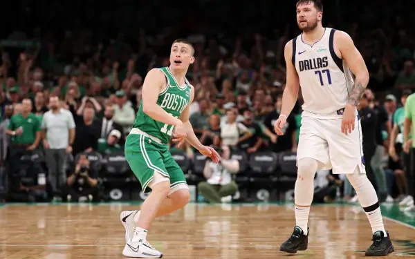 Payton Pritchard of the Boston Celtics reacts during a game against Luka Dončić of the Dallas Mavericks, captured in this vibrant 4K Ultra HD desktop wallpaper.