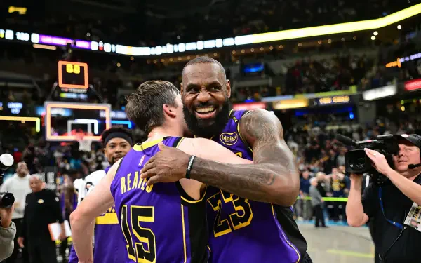 LeBron James and Austin Reaves celebrate a thrilling moment on the court, showcasing their chemistry as members of the Los Angeles Lakers in this vibrant HD wallpaper.