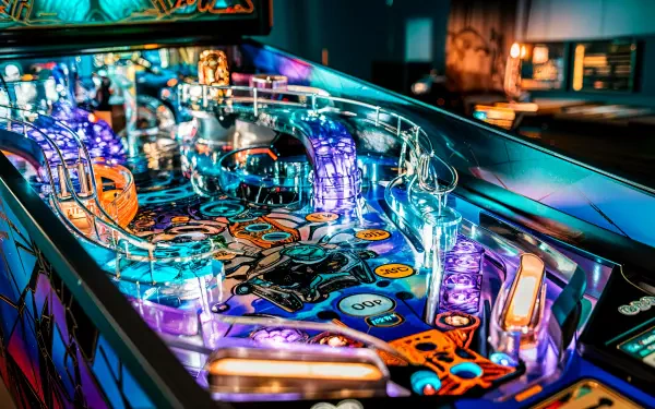 A vibrant pinball machine with illuminated features and intricate designs, showcased in a detailed 4K Ultra HD PC desktop wallpaper and background.