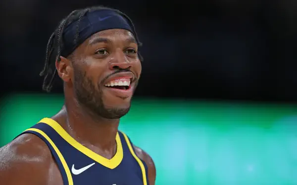HD PC desktop wallpaper featuring a close-up of basketball player Buddy Hield smiling during a game.