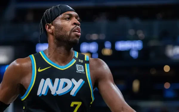 HD desktop wallpaper featuring Indiana Pacers player Buddy Hield in action, wearing a black jersey with INDY and number 7.