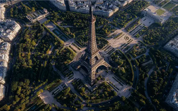 Aerial view of the Eiffel Tower surrounded by Parisian streets and greenery, captured in stunning detail for a 4K Ultra HD PC desktop wallpaper.
