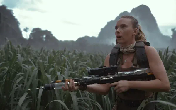 HD PC desktop wallpaper featuring Scarlett Johansson in a tense scene from the movie Jurassic World Rebirth, set against a lush, mountainous jungle backdrop.