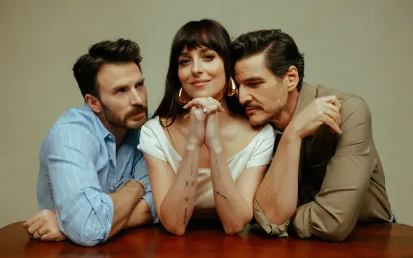 HD PC desktop wallpaper featuring Chris Evans, Dakota Johnson, and Pedro Pascal from the movie Materialists, posed closely around a table.