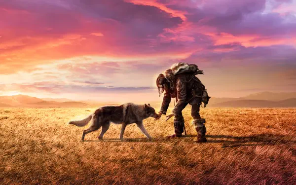 HD PC desktop wallpaper of Alpha (Movie): a lone prehistoric hunter kneeling to touch a wolf on a windswept golden plain under a vivid sunset sky.