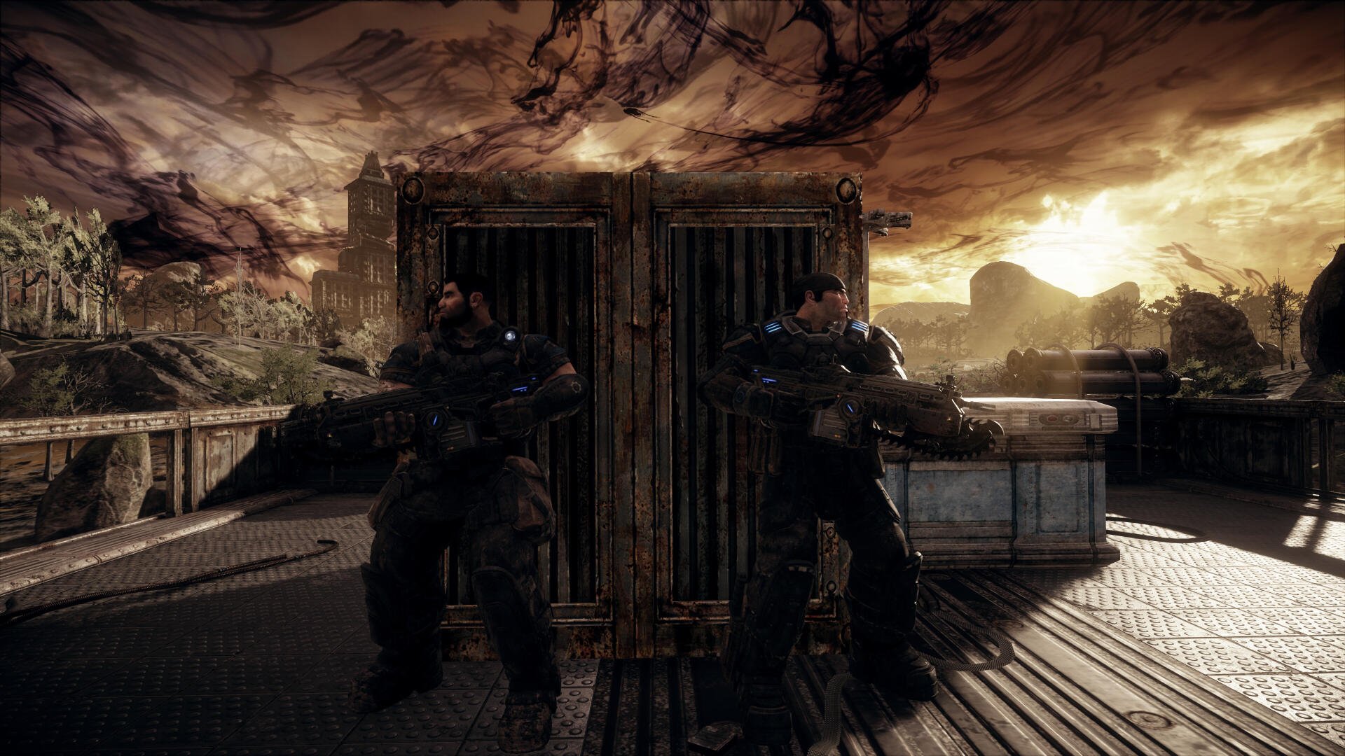Gears Of War: Reloaded video game — two armored soldiers back-to-back behind a metal barricade on a ruined rooftop at sunset. 4K Ultra HD PC desktop wallpaper.