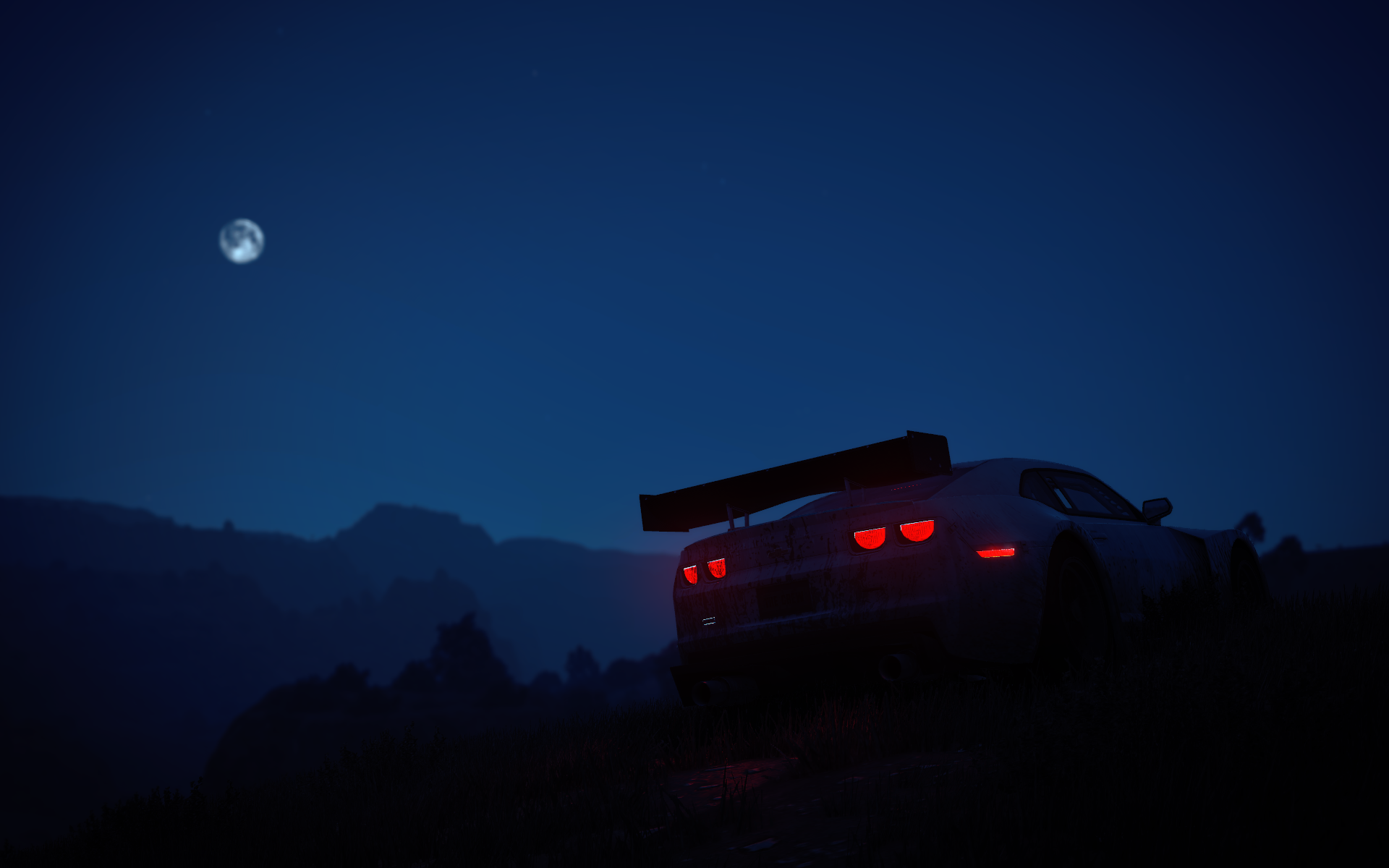 HD PC desktop wallpaper: dark night scene of a Chevrolet silhouetted on a ridge with glowing taillights under a moonlit sky, mountains outlined in blue.