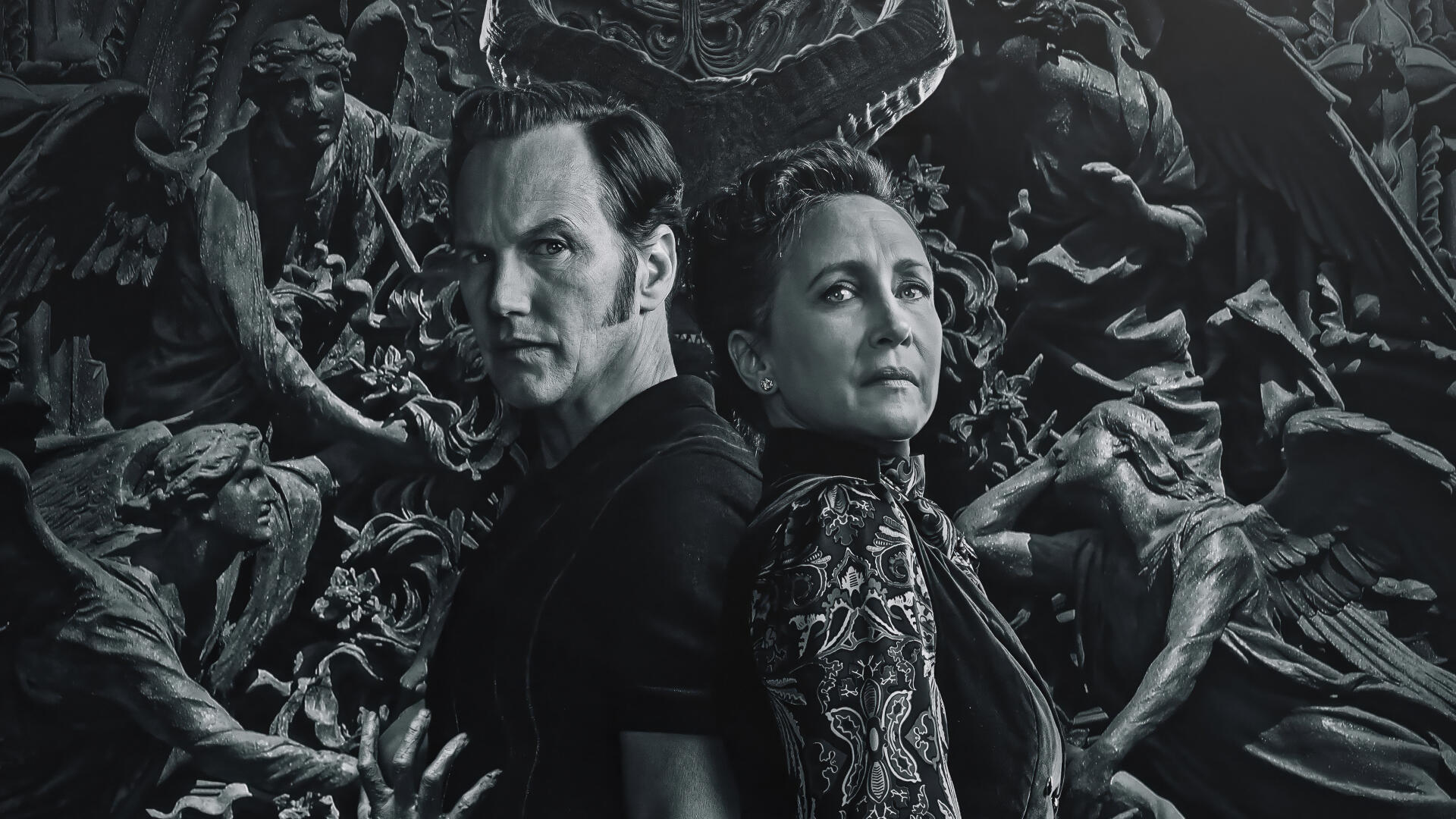 The Conjuring: Last Rites — 4K Ultra HD PC Desktop Wallpaper and Background: two solemn figures back-to-back amid a swirling mass of carved demons and anguished statues in grayscale horror.