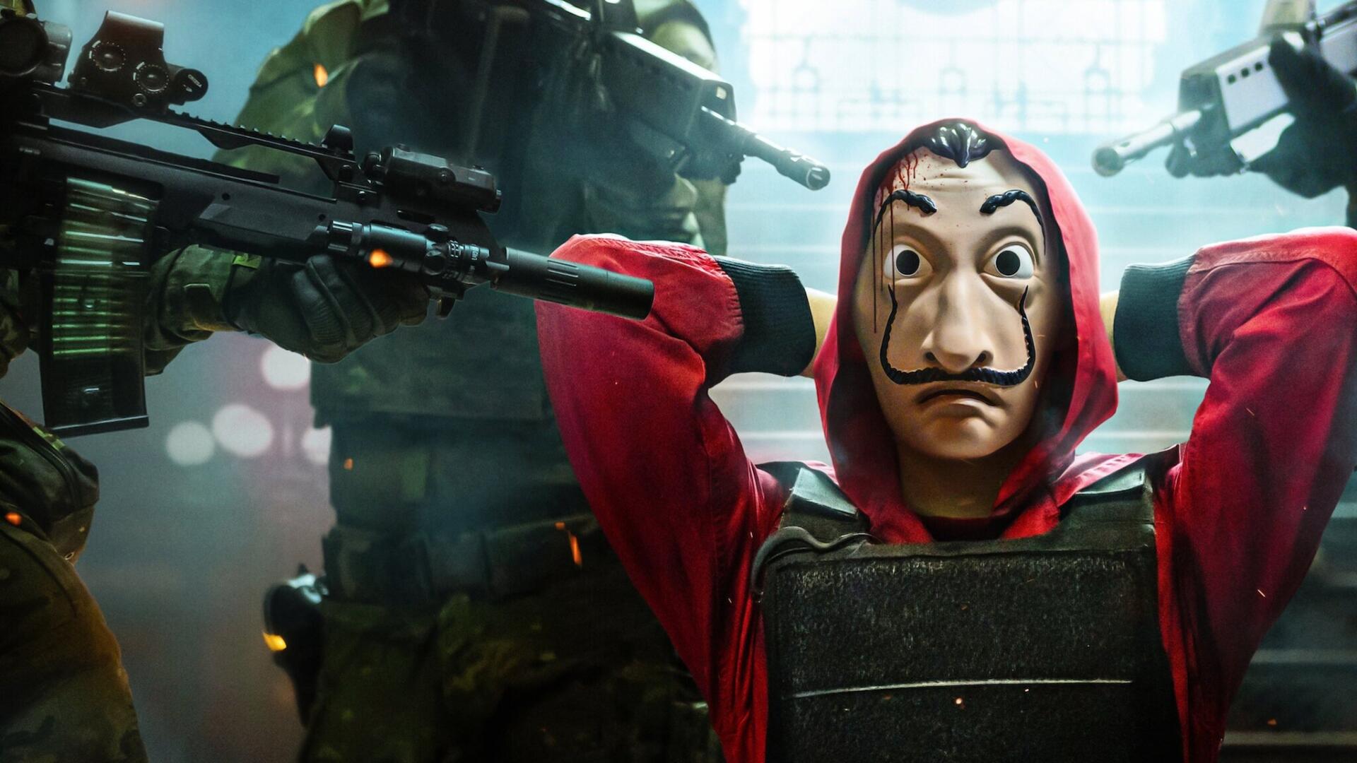 Money Heist HD PC desktop wallpaper: Dalí-masked figure in red hooded suit with hands behind head, flanked by armed soldiers in tactical gear.