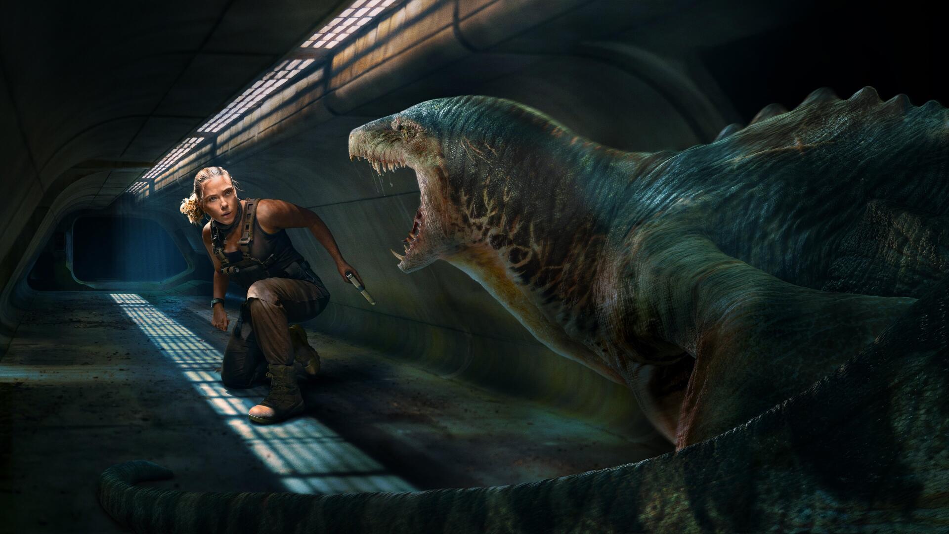 Jurassic World Rebirth 4K Ultra HD PC desktop wallpaper/background: a crouching explorer faces a roaring aquatic dinosaur emerging in a dark, industrial tunnel.