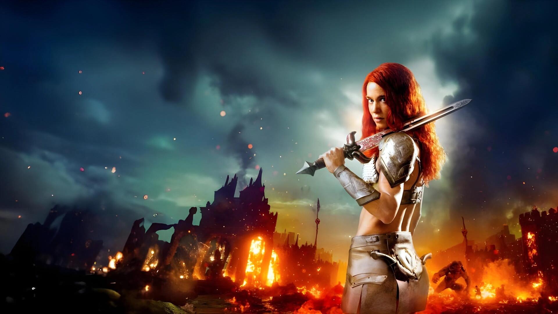 Red Sonja (2023) 4K Ultra HD PC desktop wallpaper — red-haired armored warrior brandishes a sword before a burning, stormy ruined cityscape.