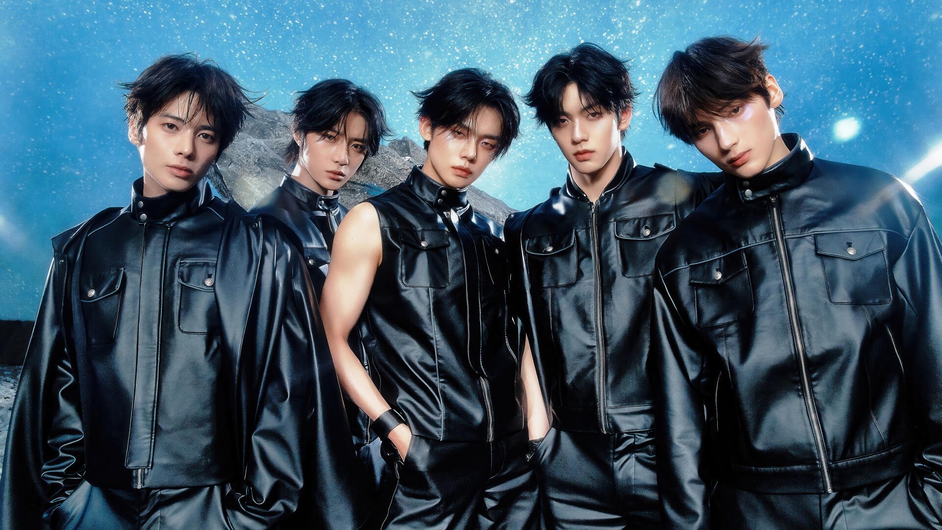 K-pop Korean boy band in matching black leather outfits, five members posed against a starry blue background — 4K Ultra HD PC desktop wallpaper and background.